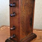 back and side view of vintage or antique wooden perpetual calendar